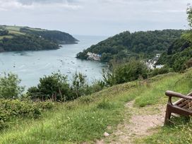 A view of a river with boats and trees at Windwhistle in Dartmouth