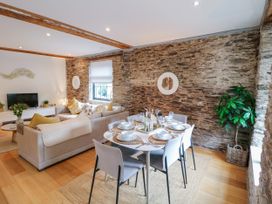 A dining area with a table set for meals at 9 The Pottery Dartmouth