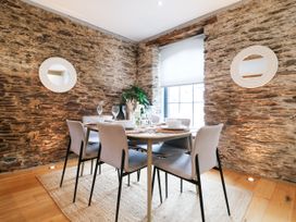 A dining room with a table and chairs at 9 The Pottery Dartmouth