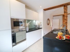 A kitchen featuring appliances and a countertop with food at 9 The Pottery in Dartmouth