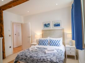 A bedroom with a bed and nightstands at 9 The Pottery in Dartmouth