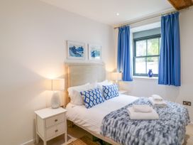 A bedroom with a bed and bedside table at 9 The Pottery in Dartmouth