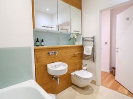 A bathroom with a bathtub, sink, and towel warmer at 9 The Pottery Dartmouth