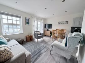 A living room with a television and dining area at Harbour View in Porthmadog