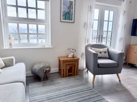 A living room with a sofa and an armchair at Harbour View in Porthmadog