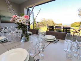 A dining room with a table set for a meal at Voebroch in Lythe