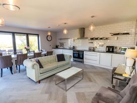 A living room with a sofa and dining area at Voebroch in Lythe