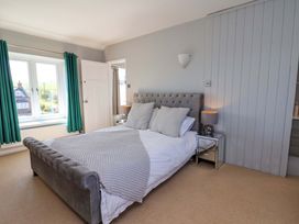 A bedroom with a bed and window at Voebroch in Lythe