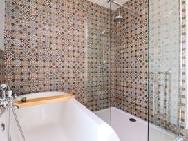 A bathroom with a bathtub and shower at Voebroch in Lythe
