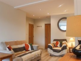 A living room with a sofa and armchair at Simples in Dartmouth