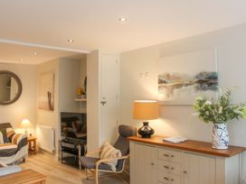 A living room with a sofa, tv, and decorative items at Simples in Dartmouth