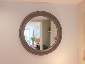 A mirror reflecting a living room at Simples in Dartmouth