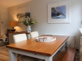 A dining area with a wooden table and chairs at Simples in Dartmouth