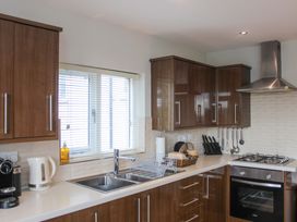 A kitchen with cabinets, sink, and appliances at Simples in Dartmouth