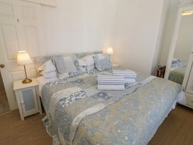 A bedroom with a bed and mirror at Heath Cottage Stratford-Upon-Avon