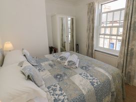 A bedroom with a bed and mirror cabinet at Heath Cottage in Stratford-Upon-Avon