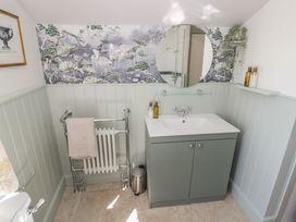 A bathroom with a mirror and sink at Heath Cottage Stratford-Upon-Avon