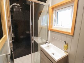 A bathroom with a shower and sink at Willow Lodge At Bridge Lake Farm & Fishery Chacombe
