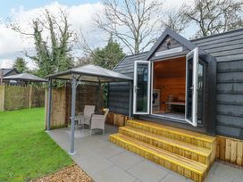An outdoor area with a gazebo and seating at Willow Lodge At Bridge Lake Farm & Fishery Chacombe