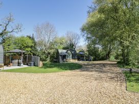 An outdoor area with a hot tub and seating at Willow Lodge At Bridge Lake Farm & Fishery Chacombe