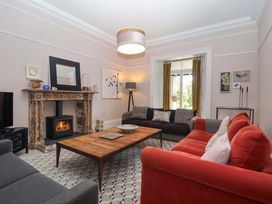 A living room with a fireplace and seating area at Barnsley House Teignmouth