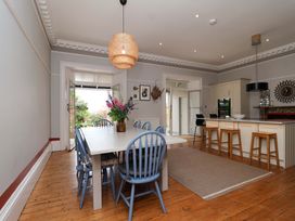 A kitchen with a dining table and chairs at Barnsley House in Teignmouth