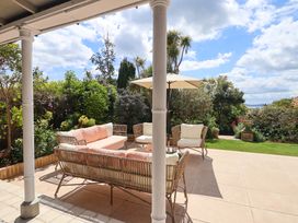 An outdoor seating area with a sofa and table at Barnsley House in Teignmouth
