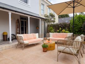 An outdoor patio with seating and a coffee table at Barnsley House Teignmouth