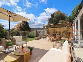 A garden with outdoor seating and dining area at Barnsley House in Teignmouth