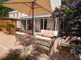 An outdoor patio with seating and a table at Barnsley House in Teignmouth