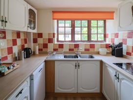 A kitchen with cabinets and a sink at The Old Bakery in South Perrott near Mosterton