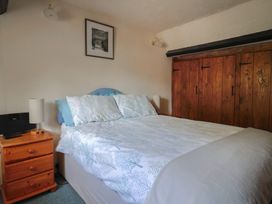 A bedroom with a bed and a bedside table at The Old Bakery in South Perrott near Mosterton