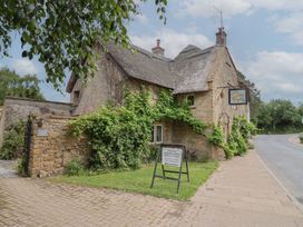 A traditional stone building with signage at The Old Bakery in South Perrott near Mosterton