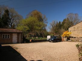 An outdoor area with a gravel driveway and a car at Jasmine Cottage South Perrott near Mosterton
