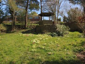 A garden with a gazebo and flowers at Jasmine Cottage South Perrott near Mosterton