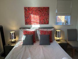 A bedroom with a bed and lamps at The Green in Whitby