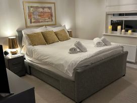 A bedroom with a bed, bedside table, and candles at The Green in Whitby