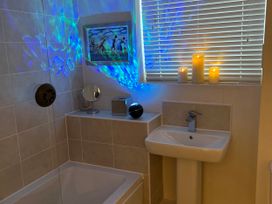 A bathroom with a bath tub and sink at The Green in Whitby
