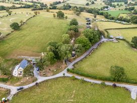 An aerial view of a house with fields and trees at The Fox Den Nantmel near Rhayader