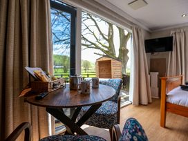 A living room with a table and chairs at The Fox Den in Nantmel near Rhayader