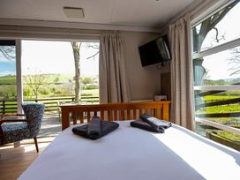 A bedroom with a bed and towels at The Fox Den in Nantmel near Rhayader