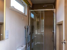 A bathroom with a shower and toilet at The Fox Den Nantmel near Rhayader