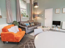 A living room with a sofa, armchair, and coffee table at Ferndale in Lynton