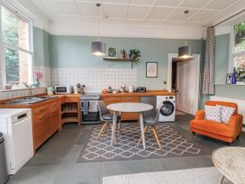A kitchen with appliances and a dining table at Ferndale in Lynton