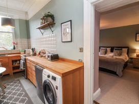 A kitchen with a washing machine and a countertop at Ferndale in Lynton