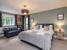 A bedroom with a bed and a sofa at Ferndale in Lynton