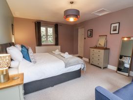 A bedroom with a bed and mirror at Ferndale in Lynton