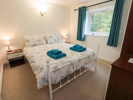 A bedroom with a double bed and lamps at Kiln How in Threlkeld