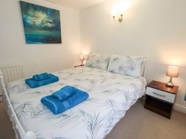 A bedroom with a bed and nightstand at Kiln How in Threlkeld