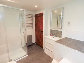 A bathroom with a shower and a vanity at Kiln How in Threlkeld
